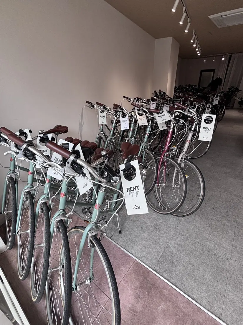 Inside the shop: a long row of tokyobikes with rental tags